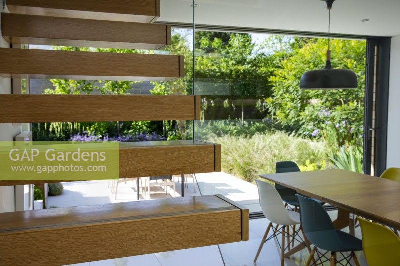 View through dining room window to modern garden