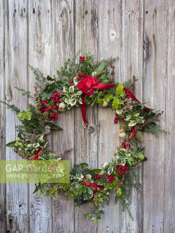 Winter Christmas wreath on bleached wooden door