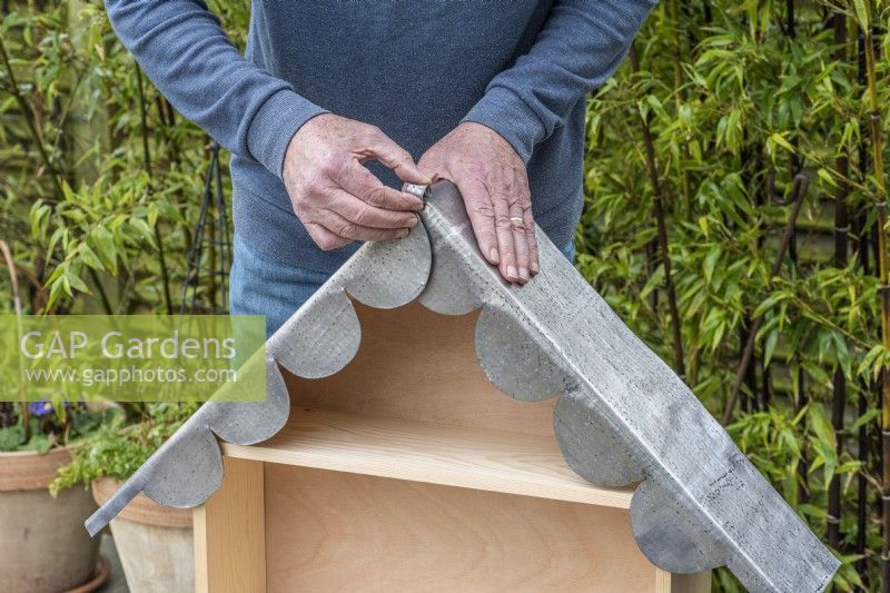 Step-by-Step Making a Plant Theatre. Step 24: carefully fit the lead to the roof, overlapping the central scalloping beneath the flap which is rolled up. 20mm is allowed to bend over the back edge, protecting the edges of the marine ply from rain