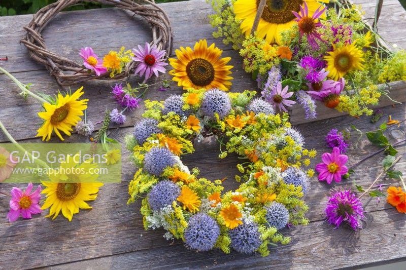Wreaths with pot marigold, fennel, globe thistles and wild carrots. Cut flowers in a trug including sunflowers, bergamot, coneflowers and fennel.