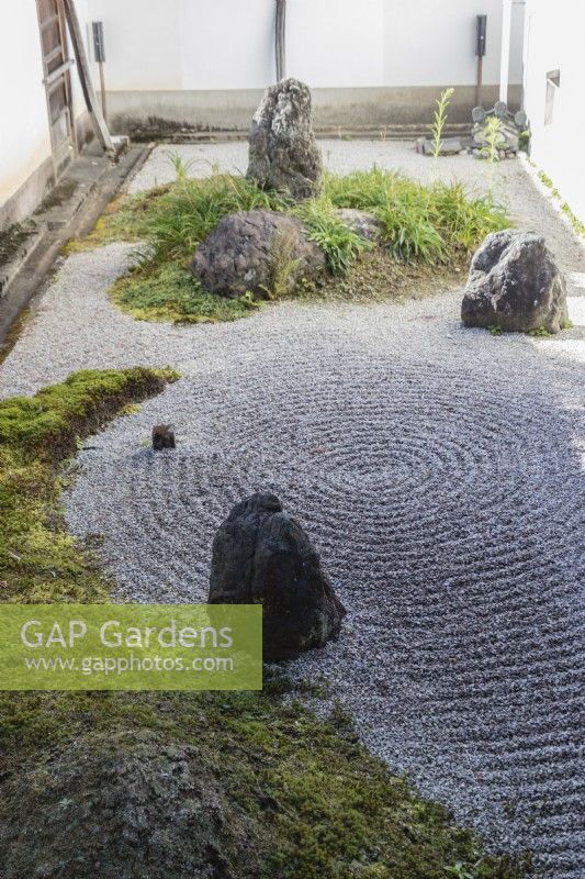 Placed rocks in raked gravel known as karesansui which translates as 