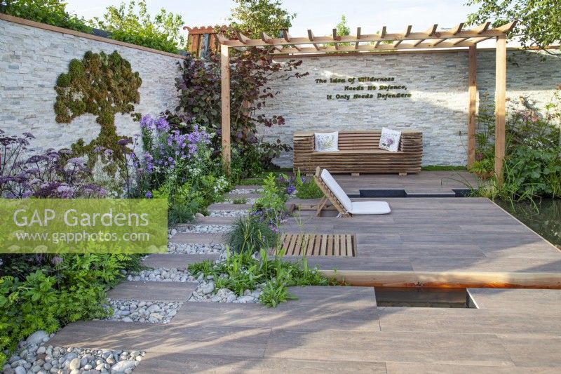 Seating area in the 'Wetland Plants - The idea of Wilderness' garden at BBC Gardener's World Live 2017, June