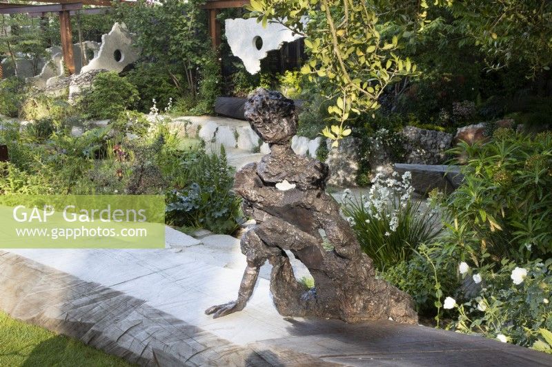 Sculptor Andrew Litten bronze Sculpture - Listening overlooks the modern contemporary garden designed by Darren Hawkes 