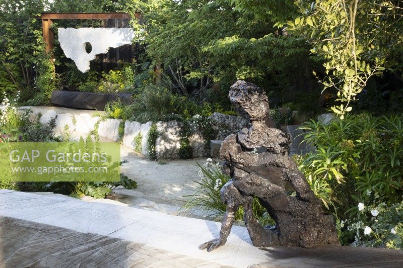 Sculptor Andrew Litten bronze Sculpture - Listening overlooks the contemporary garden designed by Darren Hawkes 