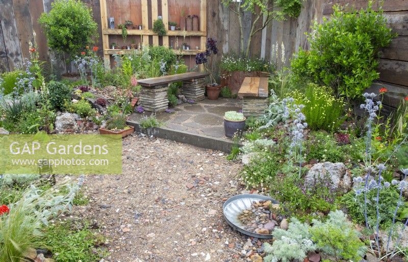 A garden made from old reclaimed salvaged building materials and timber for fencing - drought tolerant planting - Punk Rockery Garden 