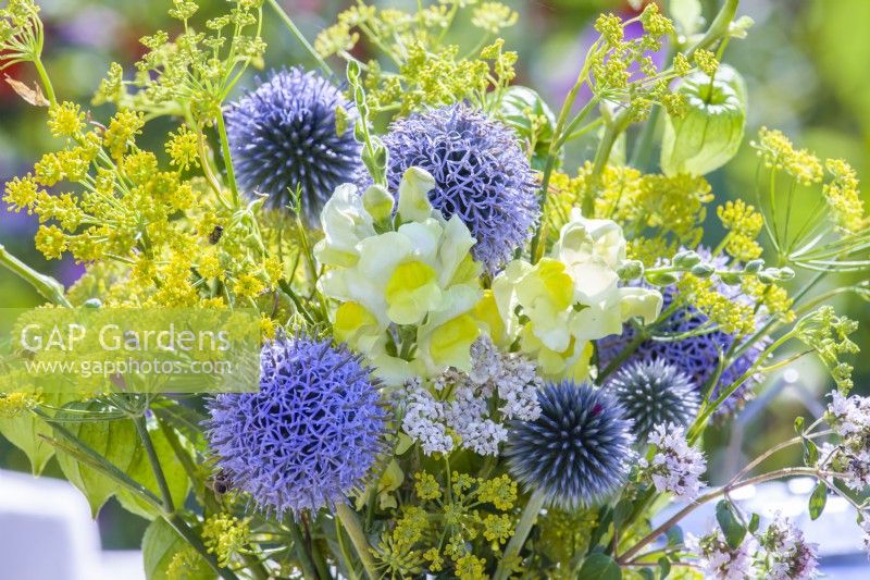 Yellow - blue themed bouquet consisting of Echinops, Snapdragon, Fennel, Achillea and Physalis.