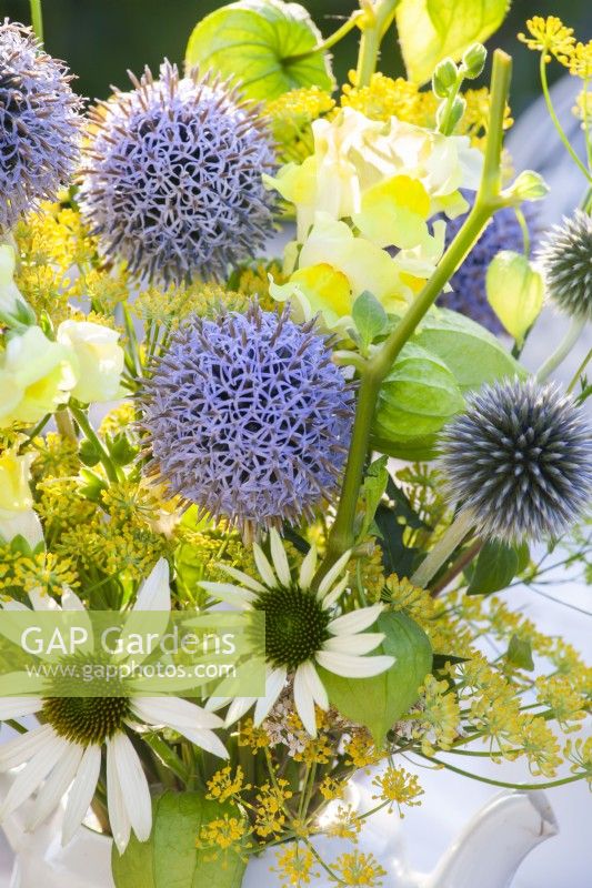 Yellow - blue - white themed bouquet consisting of Echinops, Snapdragon, Fennel, Echinacea, Achillea and Physalis.