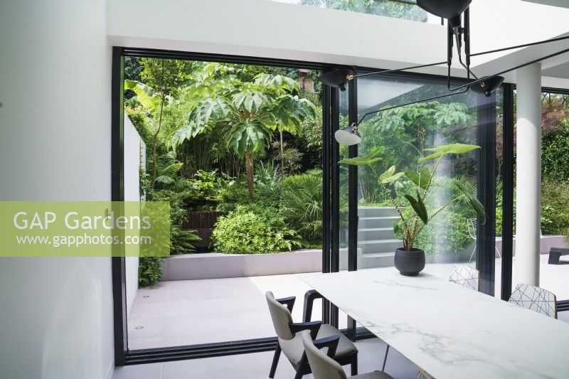 View from contemporary dining area to garden through patio doors