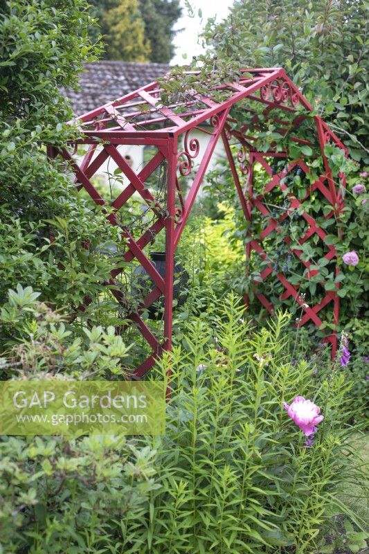 Red metal arch in garden open for Charity, Whittington, June