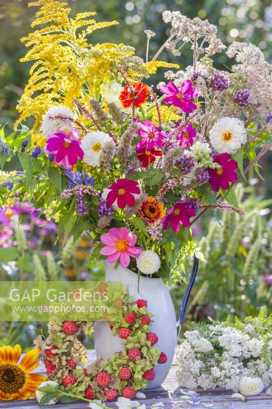 Summer bouquet in enamel jug including Cosmos, Dahlia, Zinnia, Verbena, Solidago and Persicaria.