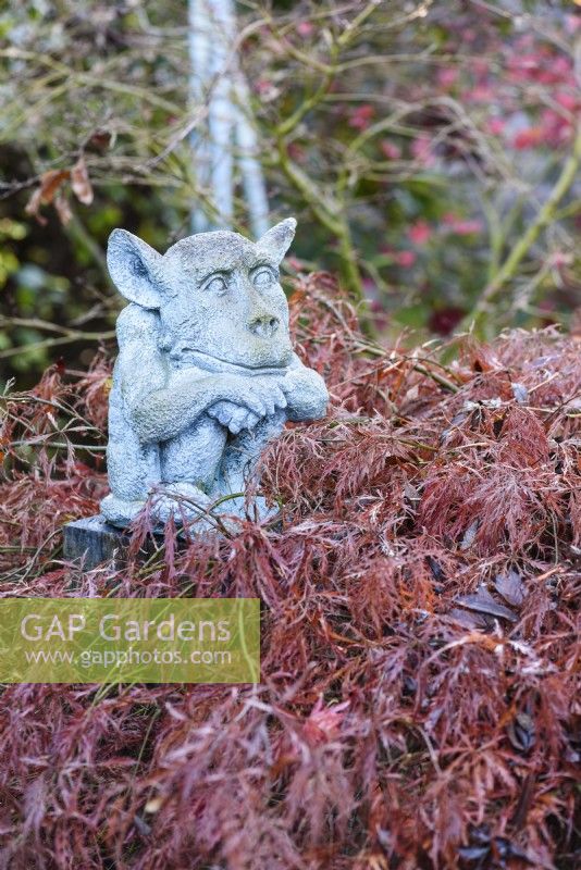 Goblin sculpture in a November garden