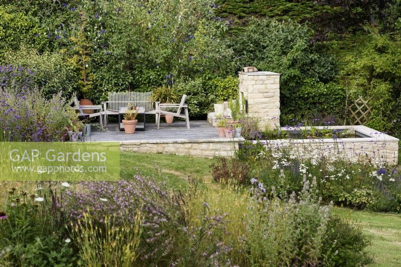 Purbeck stone platform and pond in a country garden in July