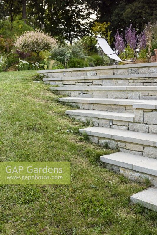 Steps and terraces of Purbeck stone in a country garden in July