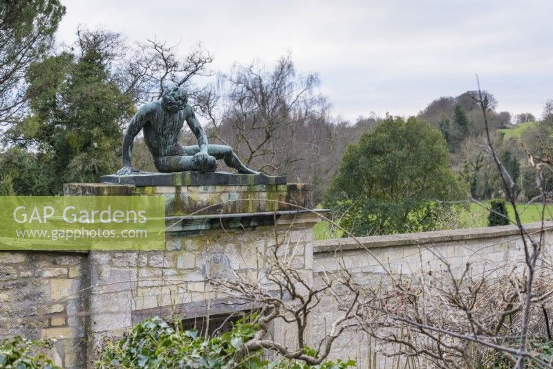 Statue of the Dying Gaul above the entrance into the walled garden at Iford Manor in January