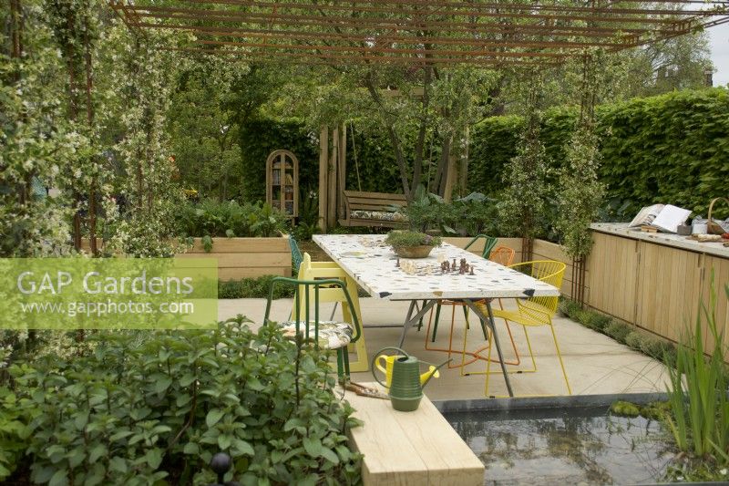 RHS Chelsea Flower Show 2023 - Dining area in the London Square Community Garden designed by James Smith