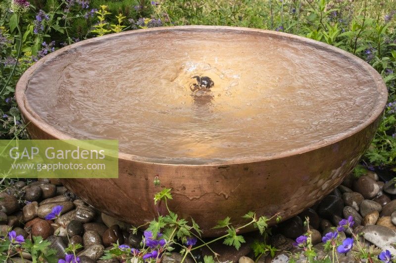 Circular copper water feature with bubble fountain. Designer Penelope Hill Smith - The Wilton London Botanical Fragrance Garden - RHS Hampton Court Palace Garden Festival.