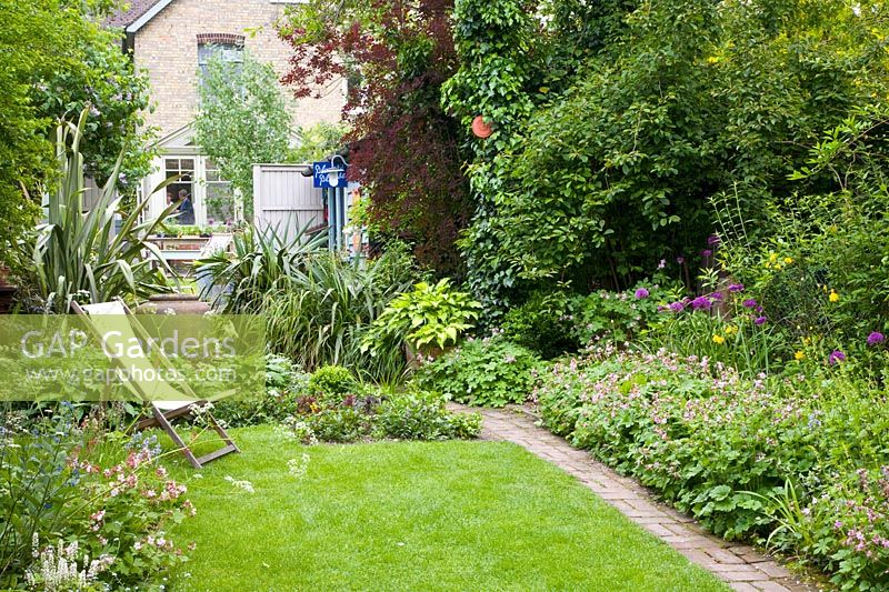 Narrow garden with lawn and path 