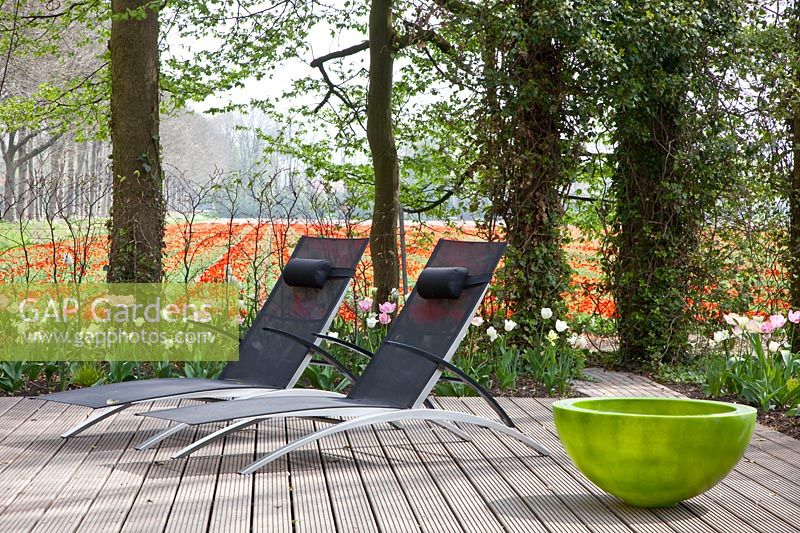 Seating area with wooden deck, view of surrounding tulip fields 