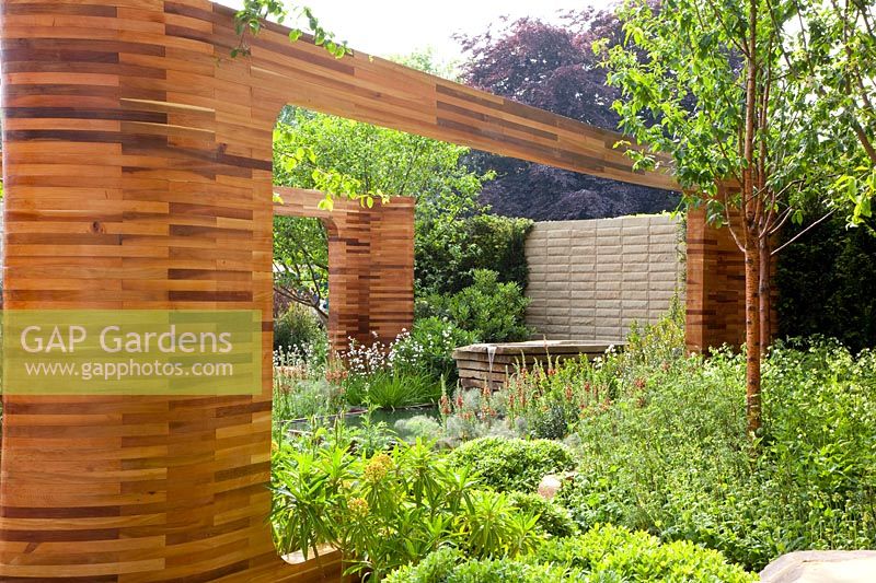Ornamental wooden arches made of red cedar in the garden 