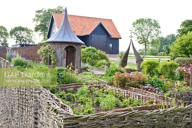 Cottage garden with willow-bordered beds and willow pavilion 
