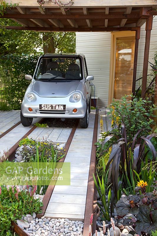 Front garden with parking space for electric car 