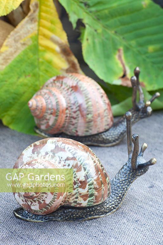 Snails made of bronze and real, polished snail shells 