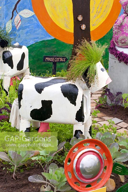 Cow made by children from recycled materials such as tin cans and plastic canisters 