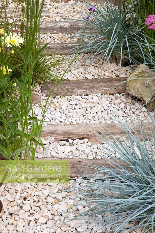 Gravel path with wooden planks 