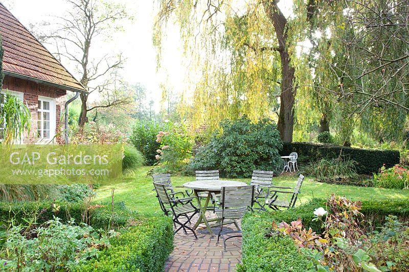 Country garden with seating area in October 