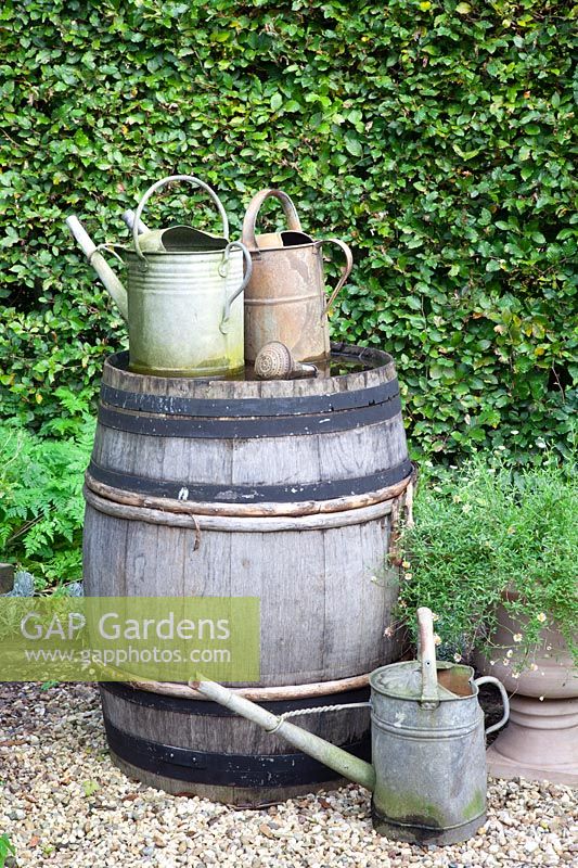 Old watering cans and water barrels 