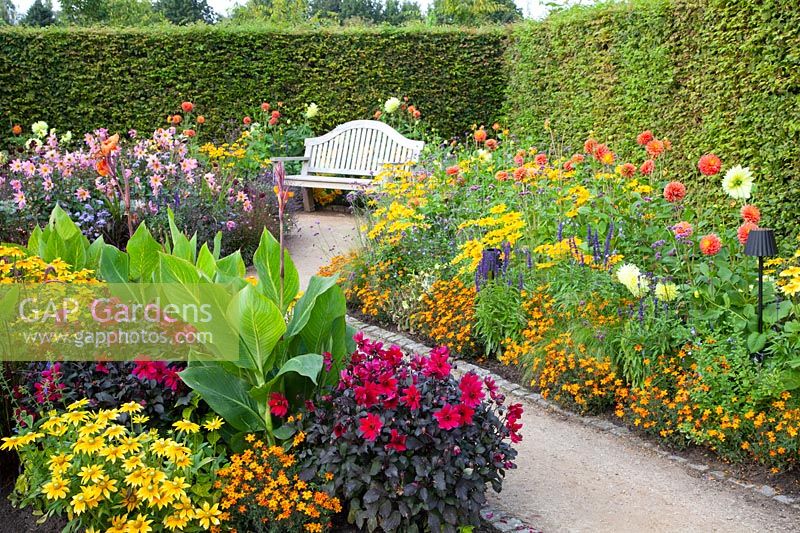 Seating area at the bed with annuals and dahlias 