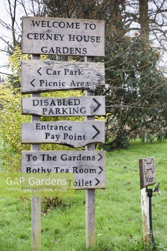 Wooden signage at Cerney House Gardens in Gloucestershire in March
