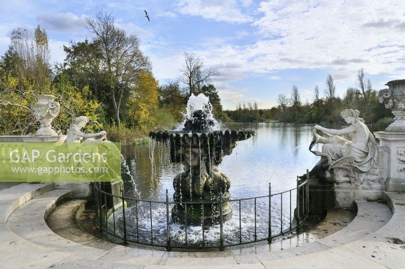 Tazza fountain and water nymph statues in the Italian Gardens, Kensington Gardens, London, with a view of Long Water connecting to The Serpentine Lake.