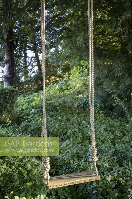 Children's garden swing with engraved seat 'and together they touched the sky'