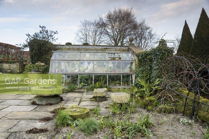 Sunken glasshouse on one side of the Paved Garden at York Gate in February