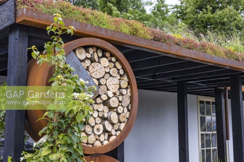 Round insect hotel made of wood and rusty ring in an urban front garden. Designer: Nicola Haines, Citroen Power of One at Bord Bia Bloom Dublin 2023