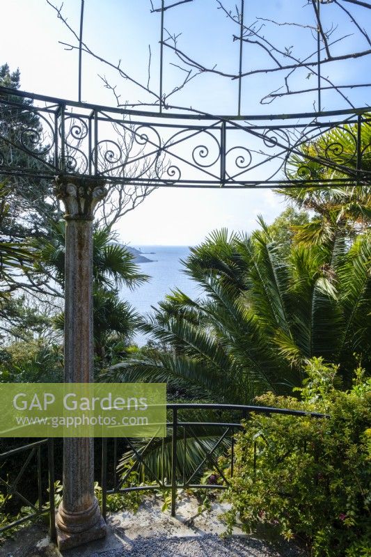 Classical style ornate metal temple with a view towards the St Mawes Harbour, hardy palms surround in this semi tropical garden