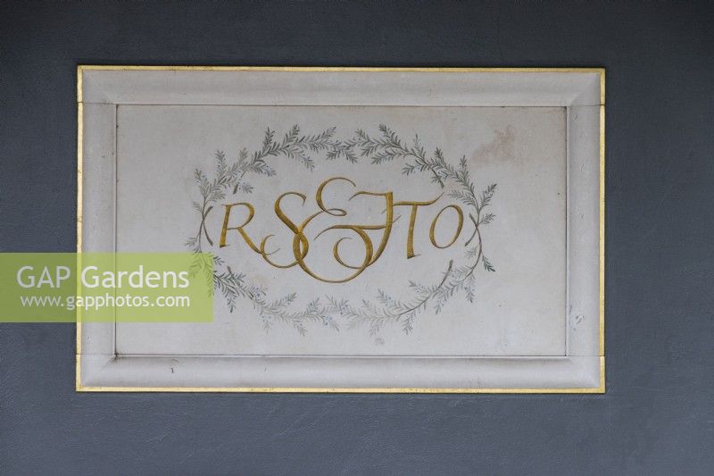  The central plaque on the wall in the Colonnade Court with initials of Roy Strong and Julia Trevelyan Oman. April. Spring. 