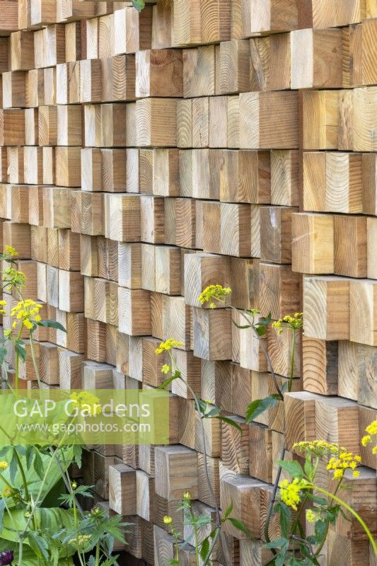 Contemporary boundary fence made from offset Douglas Fir offcuts  - 'It Doesn't Have to Cost the Earth' - designer Michael Lote - RHS Malvern Spring Festival 2024