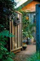 Heavy wooden garden gate at entrance to Sharon Osmond's garden in Berkeley California US