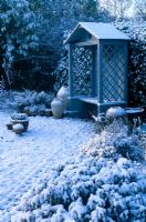 Wooden gazebo in winter garden with snow. Fairfield in Surrey