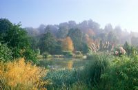 Lake surrounded with autumnal foliage - Hilliers arboretum, Hampshire
