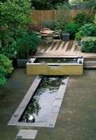 Contemporary garden with large pond and water feature in Streatham, London