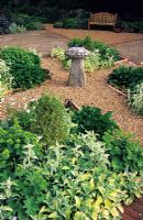Dry gravel garden with cross path and saddle stone, Cutmill in Surrey