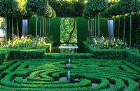 Buxus - Box labyrinth with water features backed by pleached Lime trees and mirrors at Chelsea FS 2000