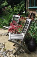 Two wooden chairs on patio at Thursley Lodge in Surrey