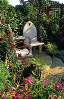 Two wooden chairs in secluded corner of garden at Hampton Court FS 2001