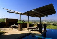 Patio with furniture and sun screens in The Stiteler Garden in Tucson, Arizona USA