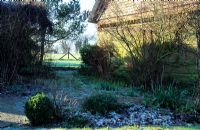 Cottage garden in winter with frost. Gowan Cottage in Suffolk