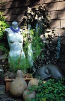 Sharon Osmund's garden in Berkeley, California, USA. Ornaments, sculpture and found objects in small suburban town fantasy garden